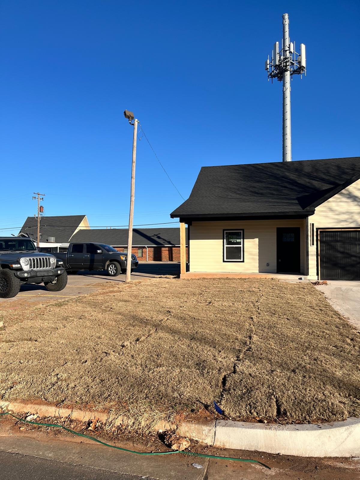 Freshly graded and seeded lawn at a new construction lot
